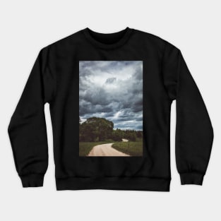 Country road under dark cloudy sky Crewneck Sweatshirt